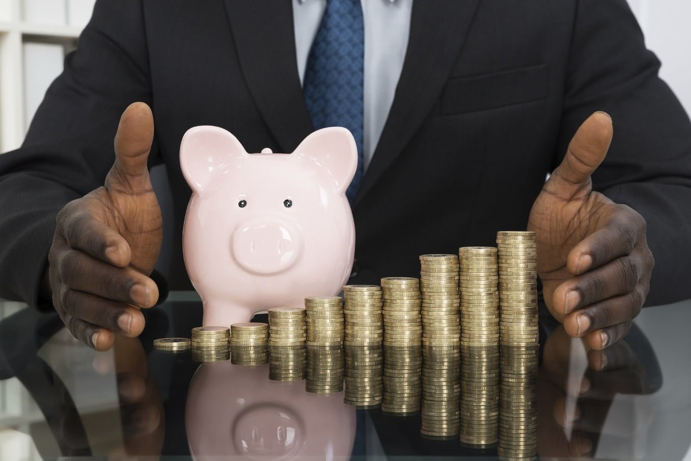 Businessman With Piggy Bk And Coins